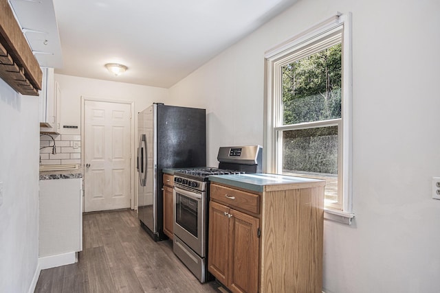 165 Kenton St SE, Grand Rapids, MI 49548 - kitchen with appliances with stainless steel finishes, wood finished floors, and brown cabinets