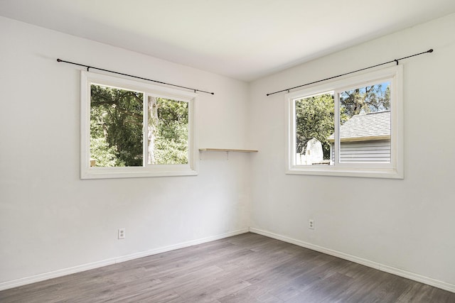 165 Kenton St SE, Grand Rapids, MI 49548 - empty room with plenty of natural light and wood finished floors