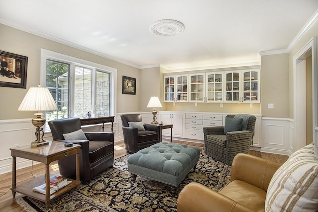 106 Kingsbury Ct, Battle Creek, MI 49015 - living room featuring ornamental molding, wood finished floors, wainscoting, and a decorative wall