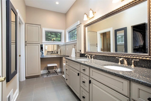 106 Kingsbury Ct, Battle Creek, MI 49015 - bathroom with tile patterned floors, double vanity, a spacious closet, and recessed lighting