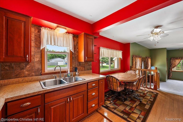 4681 Cass Elizabeth Rd, Waterford, MI 48327 - kitchen with healthy amount of natural light, light wood-type flooring, decorative backsplash, and light countertops