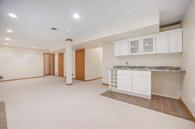270 Silver Ridge Dr, Holland, MI 49424 - kitchen featuring glass insert cabinets, white cabinets, recessed lighting, light colored carpet, and light stone counters