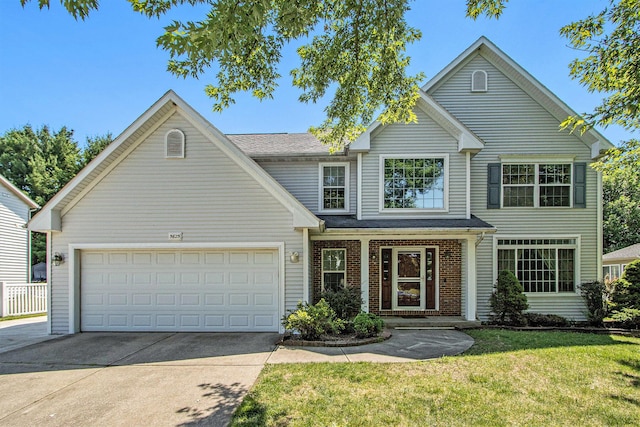 5625 Bay Meadow Trl, Portage, MI 49024 - traditional home with driveway, a front yard, an attached garage, and brick siding
