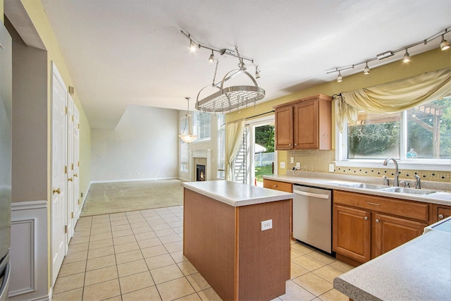 5625 Bay Meadow Trl, Portage, MI 49024 - kitchen featuring dishwasher, a center island, a lit fireplace, track lighting, and light countertops