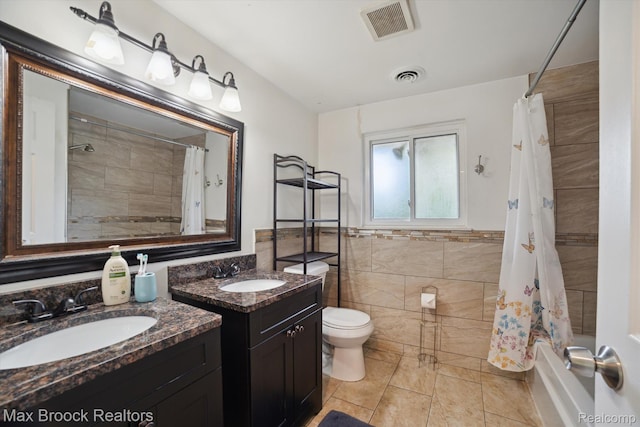 6810 Killarney Dr, Troy, MI 48098 - bathroom with tile walls, two vanities, shower / tub combo with curtain, tile patterned floors, and wainscoting