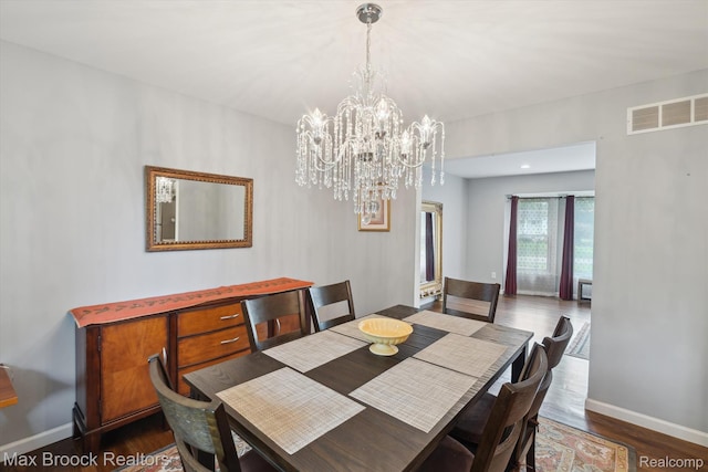 6810 Killarney Dr, Troy, MI 48098 - dining space featuring dark wood-style floors and a chandelier