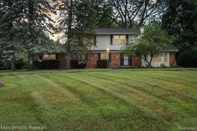 6810 Killarney Dr, Troy, MI 48098 - view of front facade with brick siding, a front lawn, and a chimney