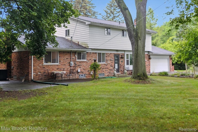 6810 Killarney Dr, Troy, MI 48098 - back of house featuring a yard, brick siding, and a garage