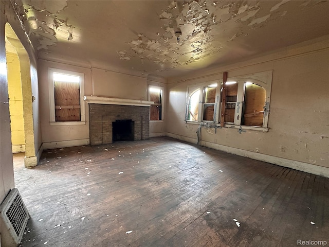 3962 Helen St, Detroit, MI 48207 - unfurnished living room featuring wood-type flooring and a fireplace