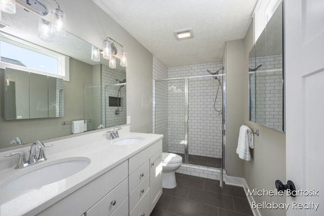 6725 Promenade St NE Unit 13, Rockford, MI 49341 - bathroom with tile patterned flooring, double vanity, a shower stall, and a textured ceiling