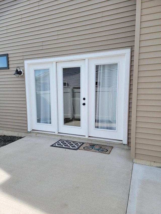 6725 Promenade St NE Unit 13, Rockford, MI 49341 - view of exterior entry featuring a patio and french doors