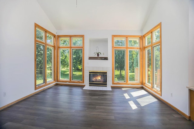 4213 Silverleaf Dr, Ypsilanti, MI 48197 - unfurnished living room featuring lofted ceiling, plenty of natural light, dark wood-style floors, and a tile fireplace