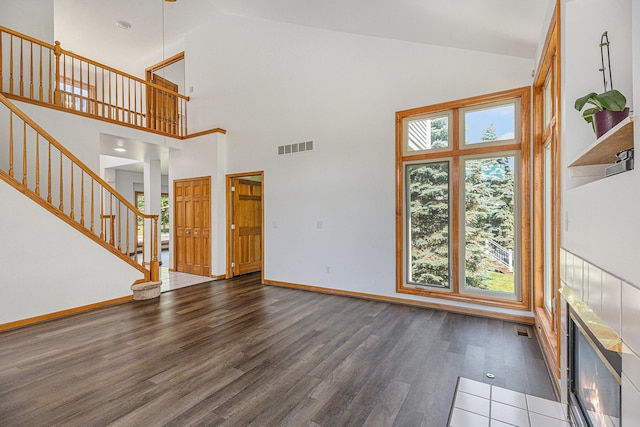 4213 Silverleaf Dr, Ypsilanti, MI 48197 - unfurnished living room featuring wood finished floors, high vaulted ceiling, and stairs