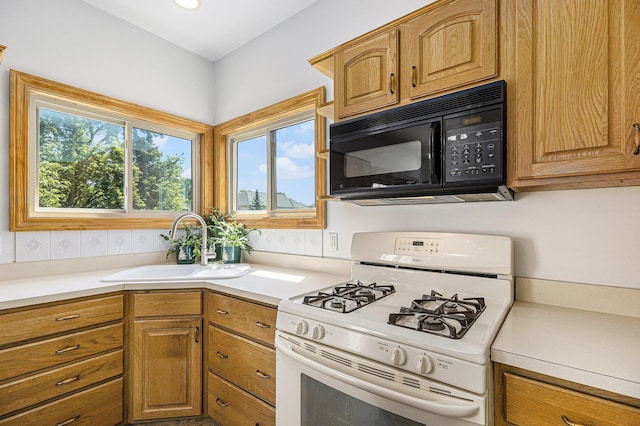 4213 Silverleaf Dr, Ypsilanti, MI 48197 - kitchen featuring white range with gas cooktop, black microwave, light countertops, and brown cabinets