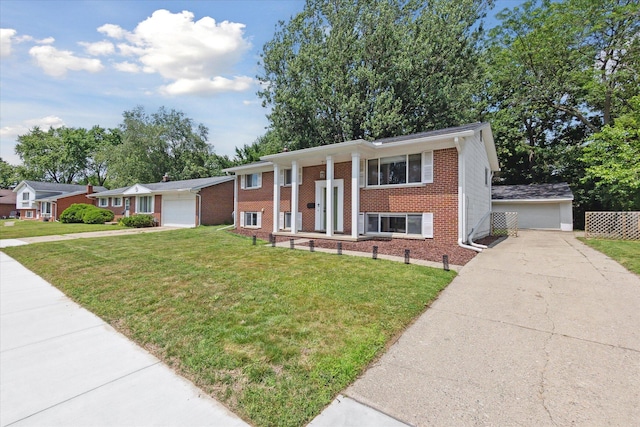 910 Newport Dr, Fenton, MI 48430 - view of front of property with brick siding, driveway, a front lawn, and a detached garage