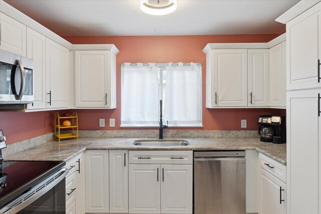 910 Newport Dr, Fenton, MI 48430 - kitchen featuring appliances with stainless steel finishes and white cabinetry