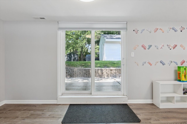 910 Newport Dr, Fenton, MI 48430 - doorway featuring wood finished floors and baseboards