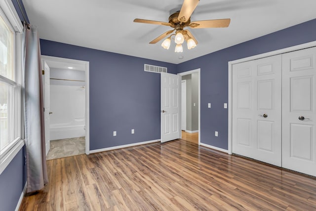 1615 Bunting Rd, Jackson, MI 49201 - unfurnished bedroom with wood finished floors, a closet, and connected bathroom