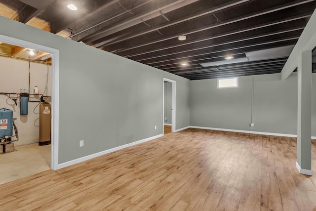 1615 Bunting Rd, Jackson, MI 49201 - below grade area with a water softener, wood-type flooring, and a water pressure tank