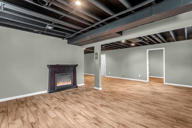 1615 Bunting Rd, Jackson, MI 49201 - finished below grade area with light wood-type flooring and a glass covered fireplace