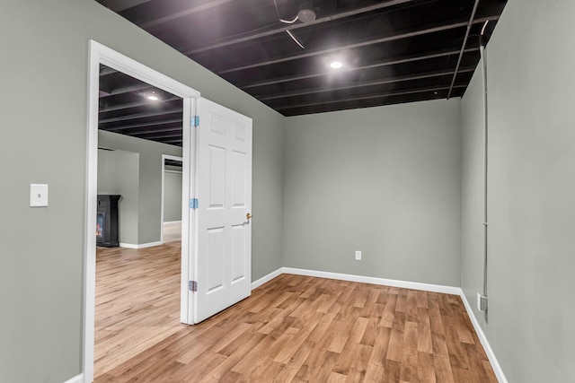 1615 Bunting Rd, Jackson, MI 49201 - empty room with light wood-style floors and a lit fireplace