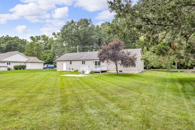 1615 Bunting Rd, Jackson, MI 49201 - rear view of house with a lawn and a deck