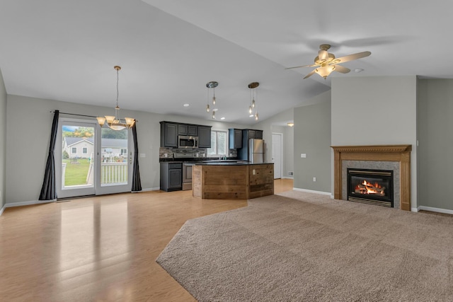 1615 Bunting Rd, Jackson, MI 49201 - kitchen with appliances with stainless steel finishes, open floor plan, dark countertops, a ceiling fan, and a kitchen island