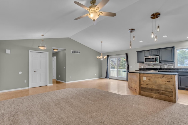 1615 Bunting Rd, Jackson, MI 49201 - kitchen featuring stainless steel microwave, electric range, dark countertops, ceiling fan, and healthy amount of natural light