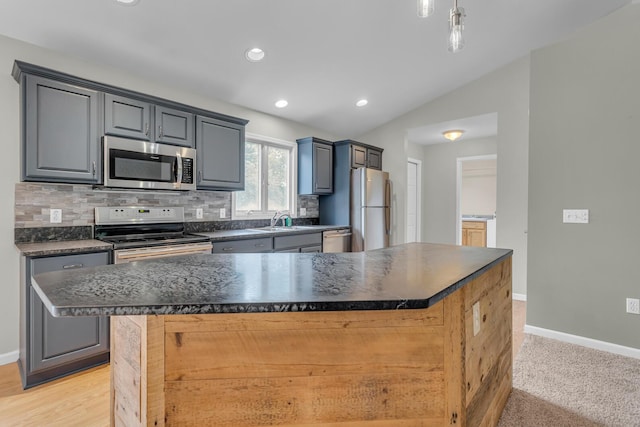 1615 Bunting Rd, Jackson, MI 49201 - kitchen with stainless steel appliances, dark countertops, a center island, backsplash, and recessed lighting
