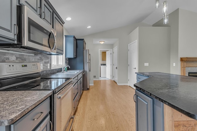1615 Bunting Rd, Jackson, MI 49201 - kitchen featuring stainless steel appliances, light wood finished floors, tasteful backsplash, recessed lighting, and dark countertops