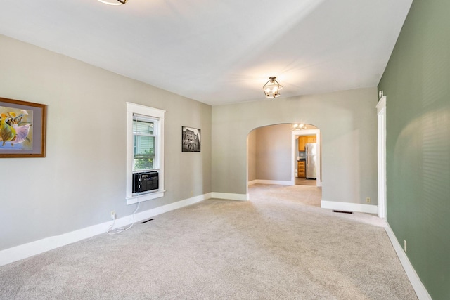 947 Pearl St, Benton Harbor, MI 49022 - spare room with arched walkways and light colored carpet