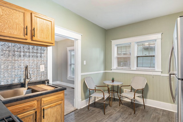 947 Pearl St, Benton Harbor, MI 49022 - kitchen with freestanding refrigerator, dark countertops, dark wood-style flooring, and a wainscoted wall