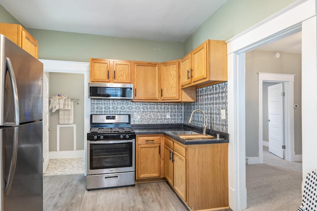 947 Pearl St, Benton Harbor, MI 49022 - kitchen with stainless steel appliances, dark countertops, tasteful backsplash, and light wood finished floors
