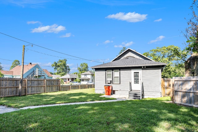 947 Pearl St, Benton Harbor, MI 49022 - back of property featuring a fenced backyard and a shingled roof