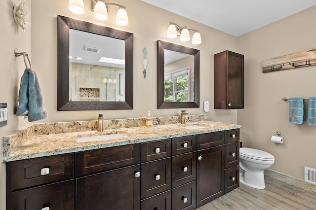 6794 Brickleton Ct, Portage, MI 49024 - bathroom featuring wood finished floors, double vanity, and a tile shower