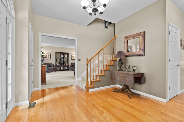 6794 Brickleton Ct, Portage, MI 49024 - entrance foyer with stairway, wood finished floors, and a chandelier