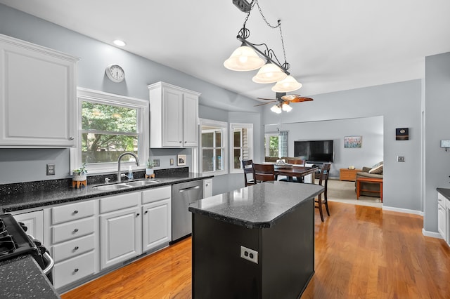 6794 Brickleton Ct, Portage, MI 49024 - kitchen with stainless steel dishwasher, white cabinetry, open floor plan, ceiling fan, and a center island
