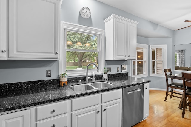 6794 Brickleton Ct, Portage, MI 49024 - kitchen featuring stainless steel dishwasher, white cabinetry, light wood-type flooring, and dark stone counters