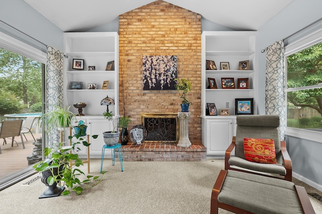 6794 Brickleton Ct, Portage, MI 49024 - carpeted living area with vaulted ceiling, built in features, healthy amount of natural light, and a brick fireplace