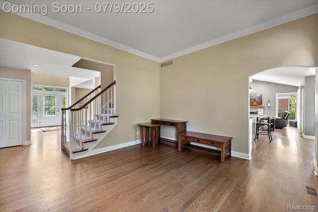 6591 Tree Knoll Dr, Troy, MI 48098 - stairs featuring arched walkways, plenty of natural light, wood finished floors, and ornamental molding