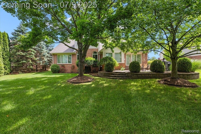 6591 Tree Knoll Dr, Troy, MI 48098 - view of property hidden behind natural elements featuring a front lawn and brick siding