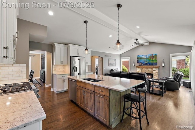 6591 Tree Knoll Dr, Troy, MI 48098 - kitchen with stainless steel appliances, arched walkways, a ceiling fan, open floor plan, and recessed lighting