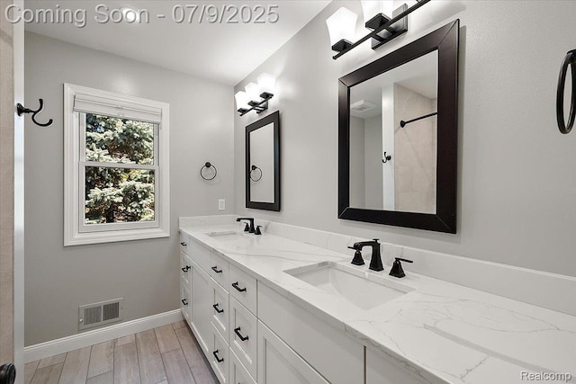 6591 Tree Knoll Dr, Troy, MI 48098 - full bath featuring double vanity and wood finished floors