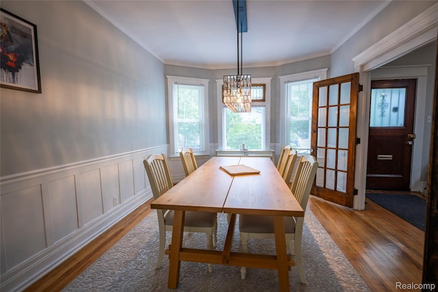 1731 Parker St, Detroit, MI 48214 - dining room with wood finished floors, a chandelier, crown molding, and a wainscoted wall