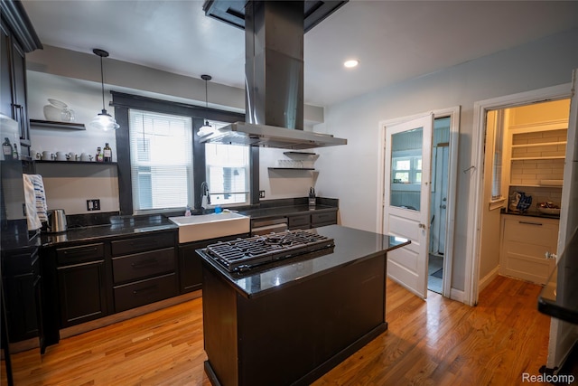 1731 Parker St, Detroit, MI 48214 - kitchen featuring open shelves, island range hood, black gas cooktop, light wood-style flooring, and a center island