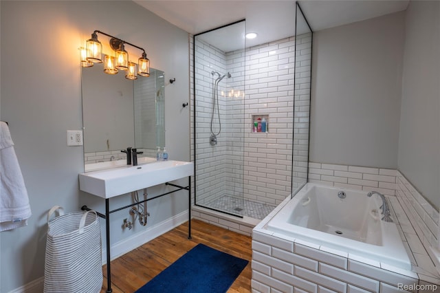 1731 Parker St, Detroit, MI 48214 - bathroom featuring tiled shower, a bath, and wood finished floors