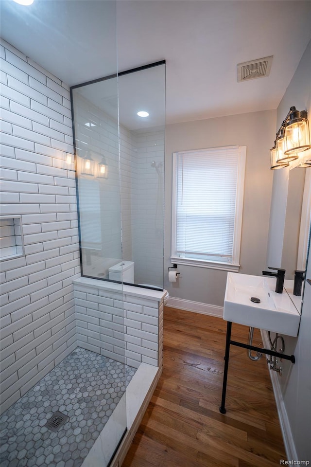 1731 Parker St, Detroit, MI 48214 - bathroom featuring a walk in shower and wood finished floors