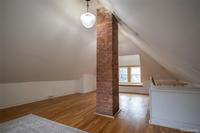 1731 Parker St, Detroit, MI 48214 - additional living space with ornate columns, vaulted ceiling, and wood finished floors