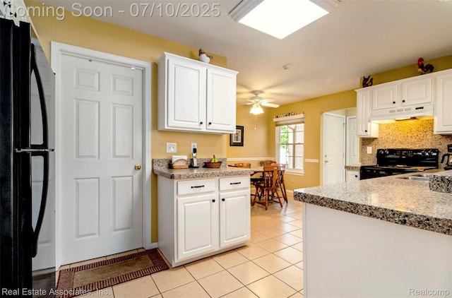 41503 Haggerty Woods Ct Unit 35, Canton, MI 48187 - kitchen with black appliances, under cabinet range hood, light tile patterned floors, a ceiling fan, and white cabinets