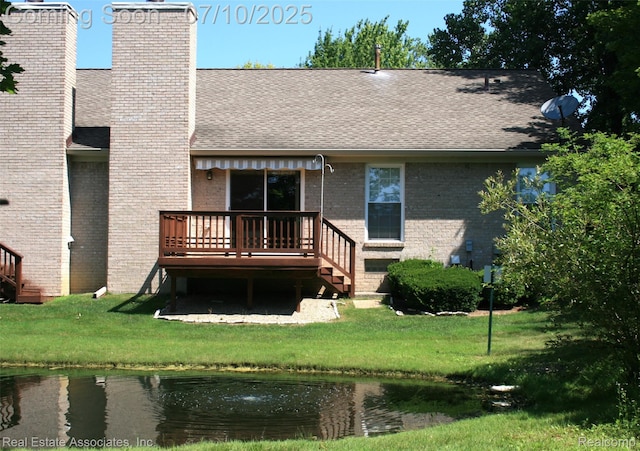41503 Haggerty Woods Ct Unit 35, Canton, MI 48187 - rear view of property with a deck, brick siding, a yard, a shingled roof, and a chimney